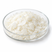 White Cutina AGS glycol distearate flakes in a clear glass Petri dish on white