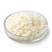 Illustration of Glyceryl Stearate and PEG-100 Stearate ivory pastilles in a glass dish