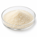 Fine ivory Span 60 sorbitan stearate grains in a clear glass Petri dish on white