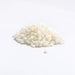 White Symbiomuls GC MB emulsifier pellets heaped on a white surface